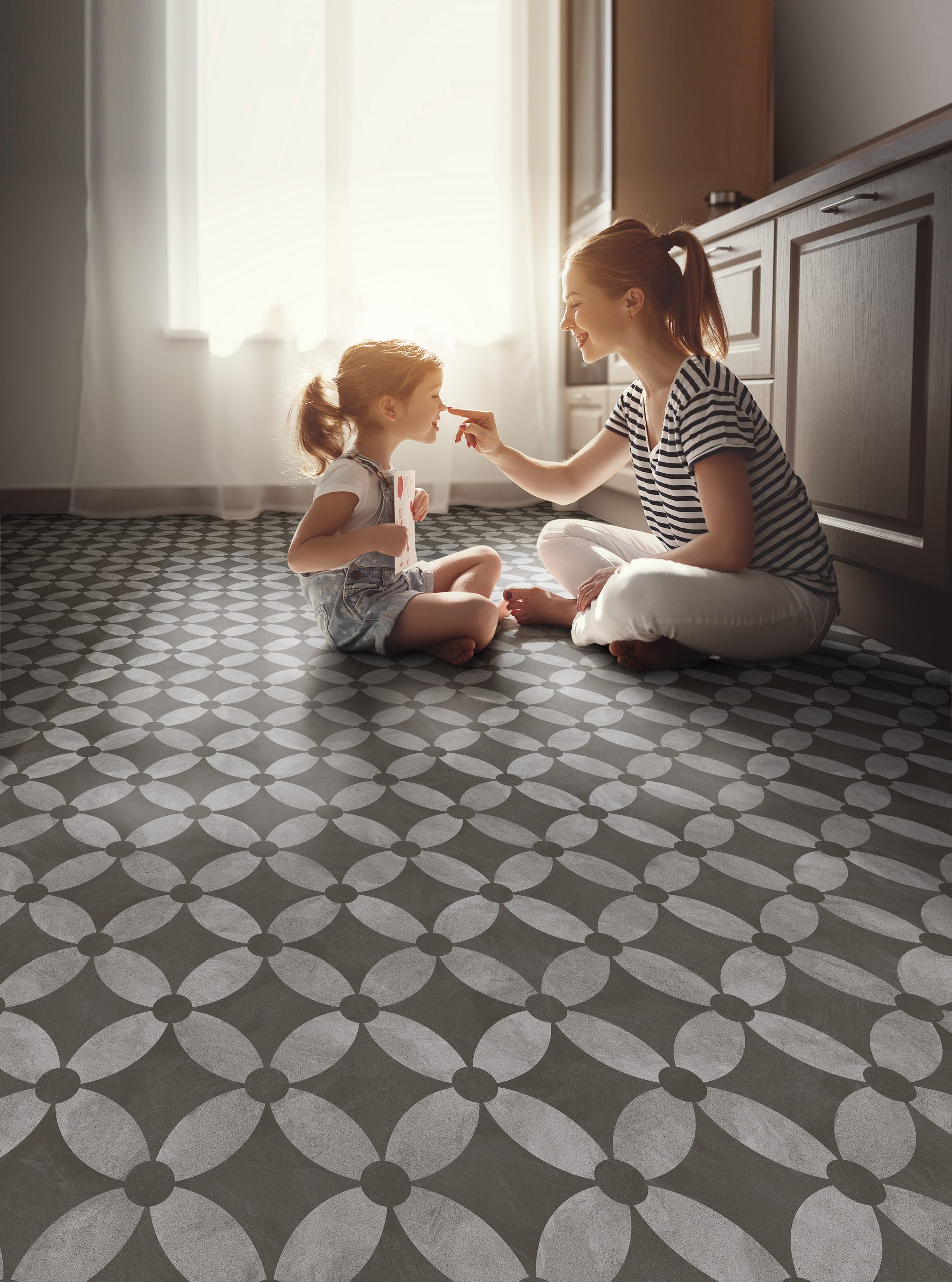 patterned flooring with mother and child sitting